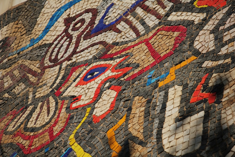 a close up of a mosaic design on the side of a building