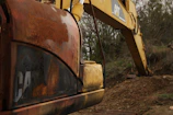 Close-up of a rugged used excavator with worn tracks and a sturdy arm.