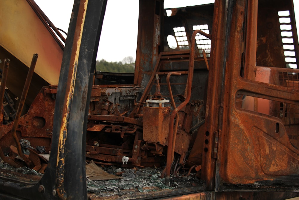 a rusted out train car sitting on top of a train track