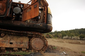 Mining equipment partially coated with rust-resistant epoxy in a rugged outdoor setting