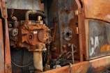 Detailed shot of rust removal and surface preparation on industrial machinery.