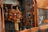 Close-up of chemical engineer inspecting corrosion on industrial equipment
