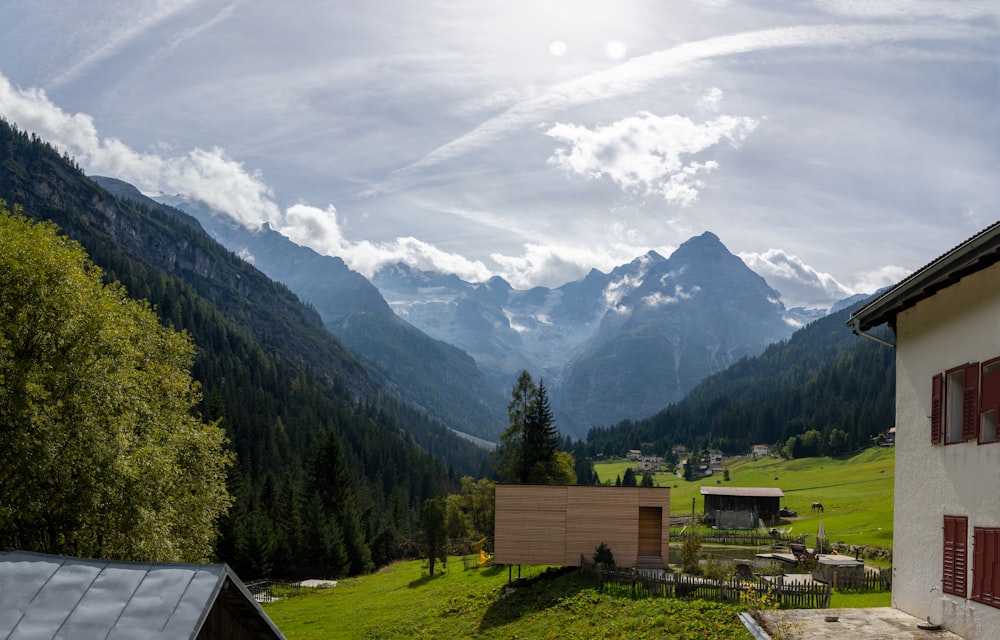 a view of a mountain range with a house in the foreground