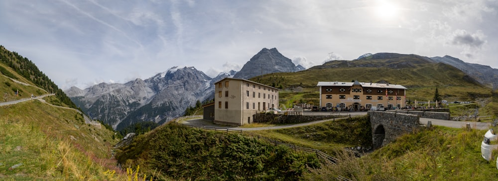 a house on a hill with mountains in the background