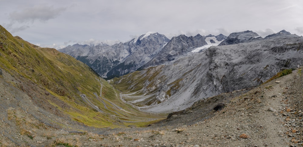 a view of a mountain range from the top of a hill