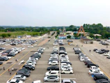 A wide parking area filled with cars during a busy corporate event at the resort.