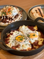 A rustic cast iron skillet with cannabis-infused breakfast hash topped with a perfectly cooked egg.