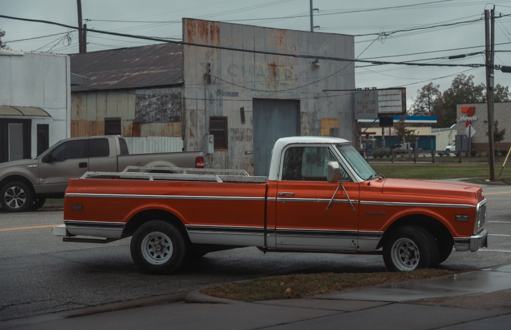 an orange truck parked on the side of the road