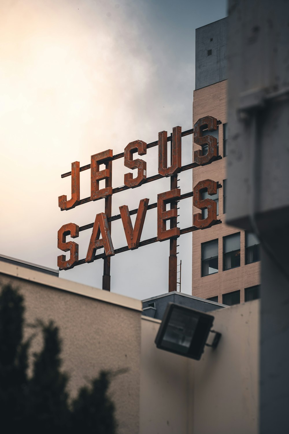 a sign that says jesus saves on top of a building