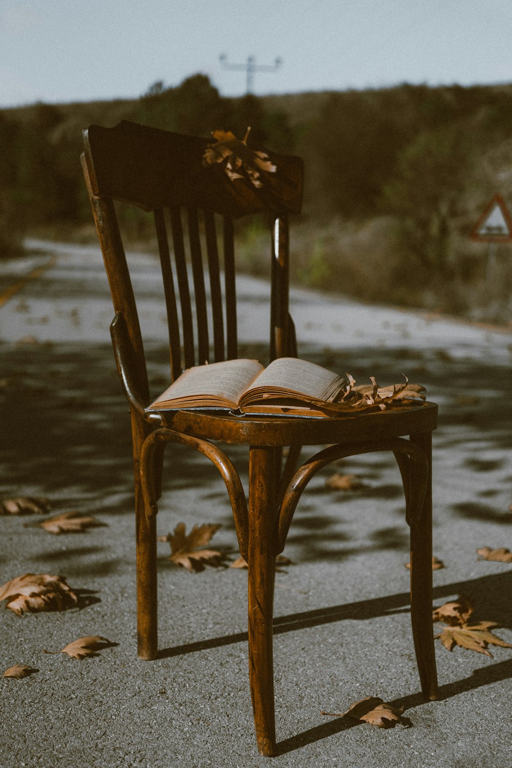 a wooden chair with an open book on it