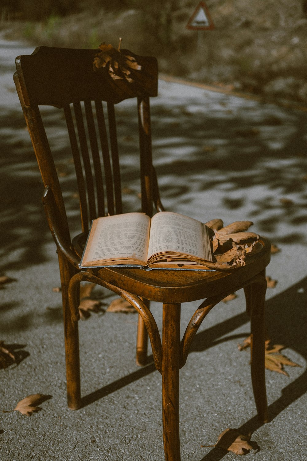 a wooden chair with an open book on it
