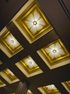 Modern living room ceiling with elegant plaster moldings and recessed lighting.