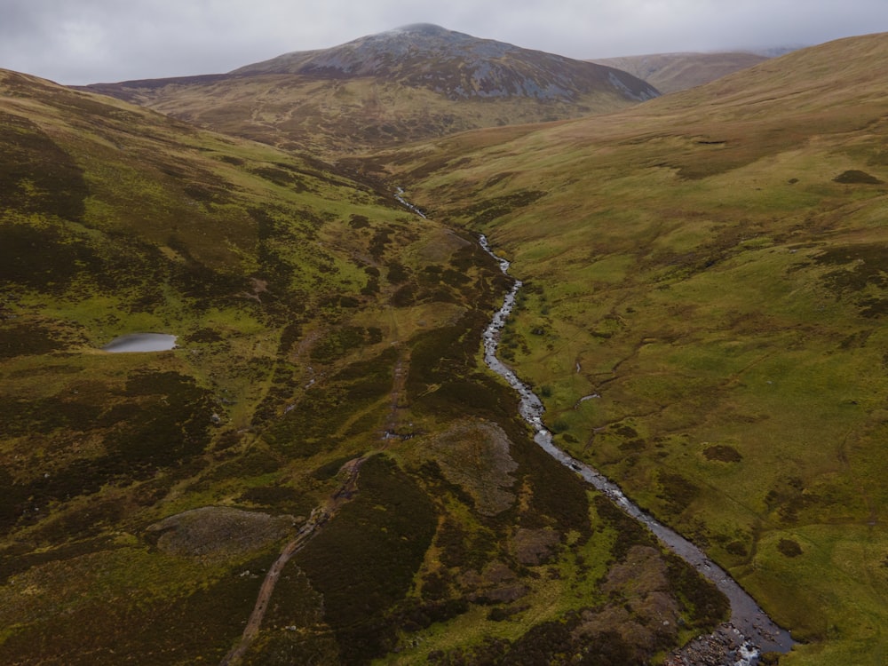 a river running through a lush green valley