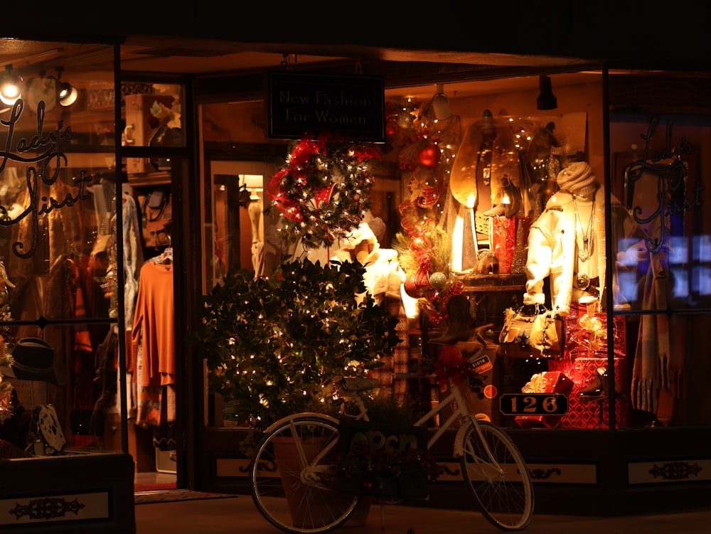 a bicycle parked in front of a store window