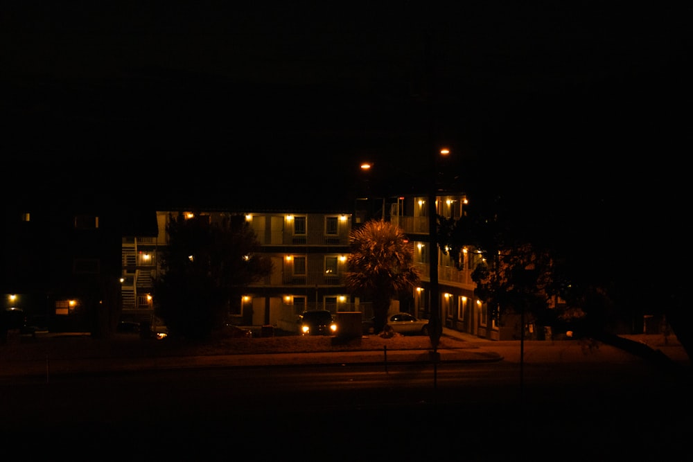 a building lit up at night with street lights