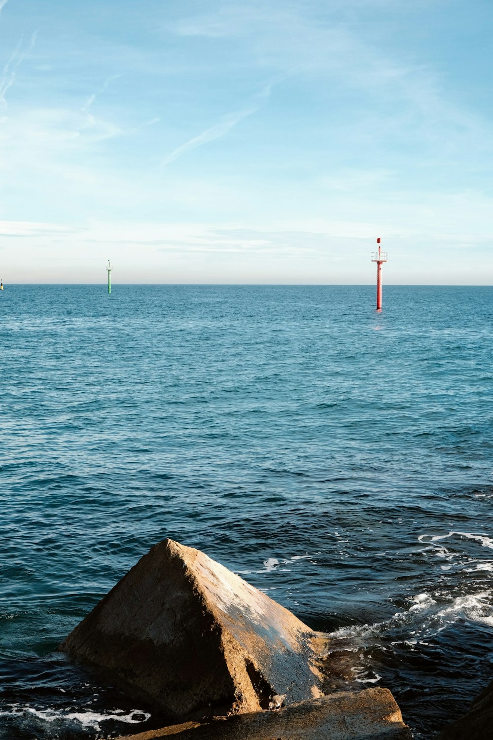 a large rock in the middle of a body of water