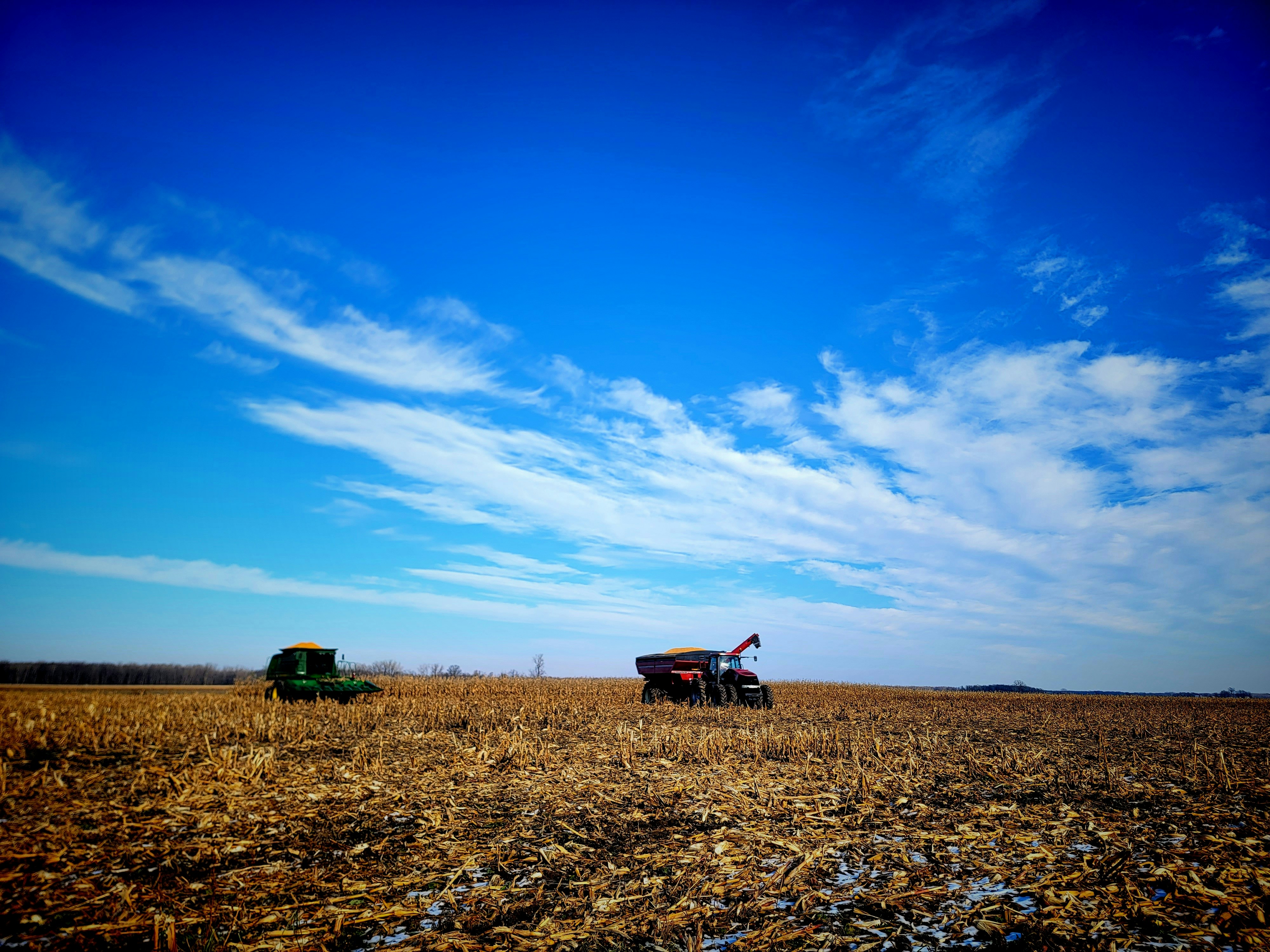 a couple of trucks are parked in a field