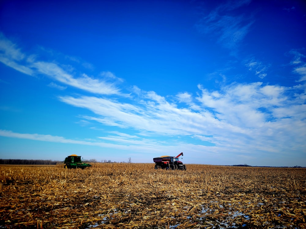 a couple of trucks are parked in a field