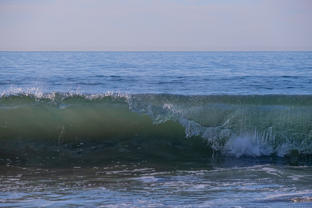 a person riding a surfboard on a wave in the ocean