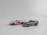 Two toy cars are positioned on a plain background. One is designed in a sleek silver color with golden rims, while the other is a convertible styled in white with red and blue accents.