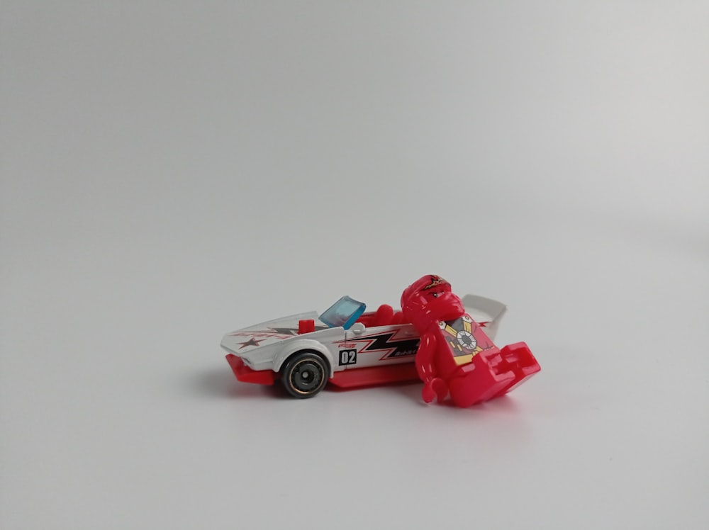 a toy car with a lego figure on top of it