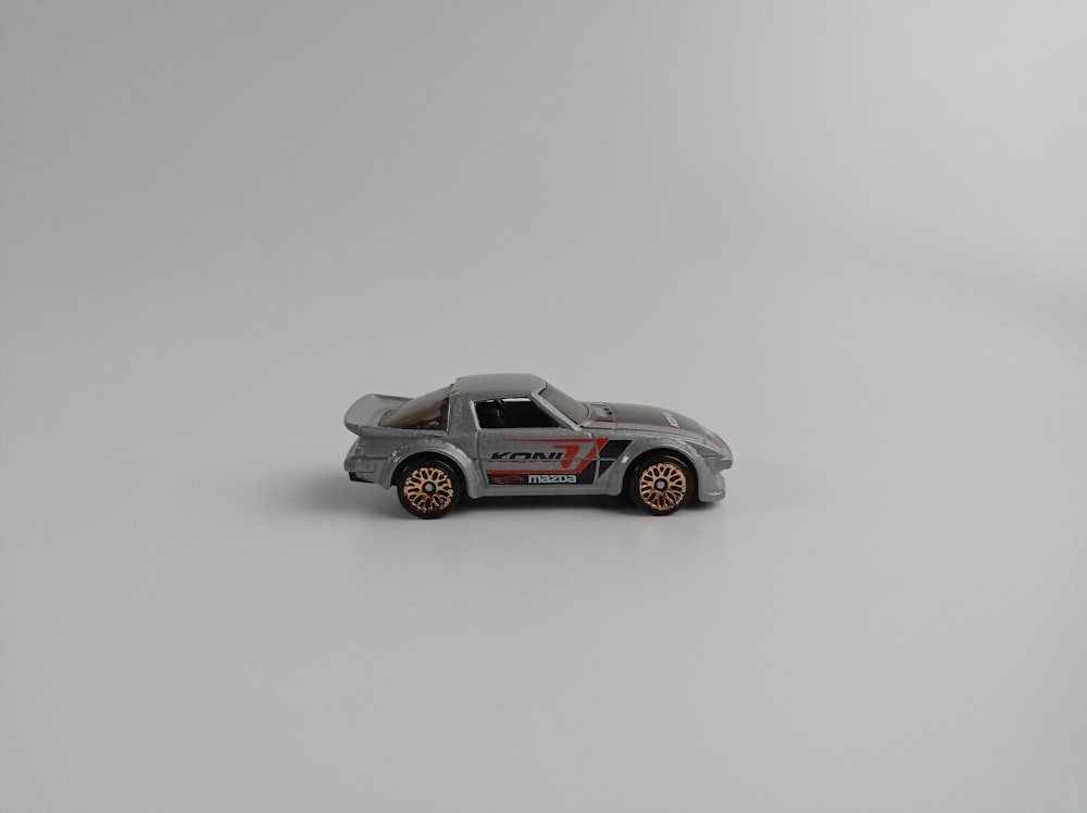a toy car is shown on a white surface