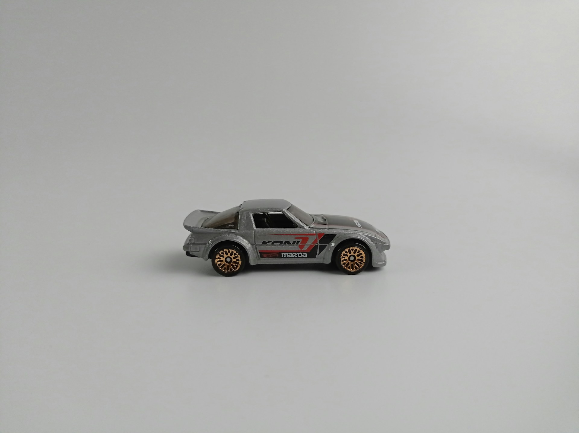 a toy car is shown on a white surface