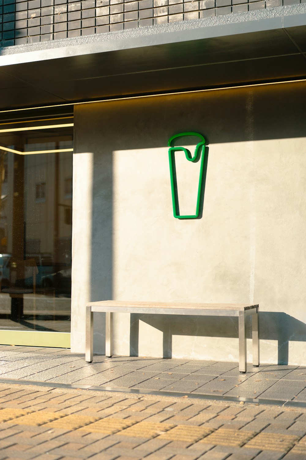 a white bench sitting in front of a building