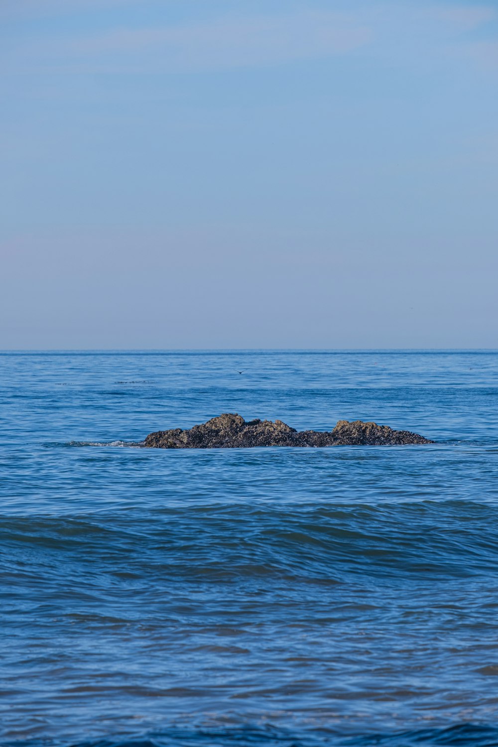 a lone rock in the middle of the ocean