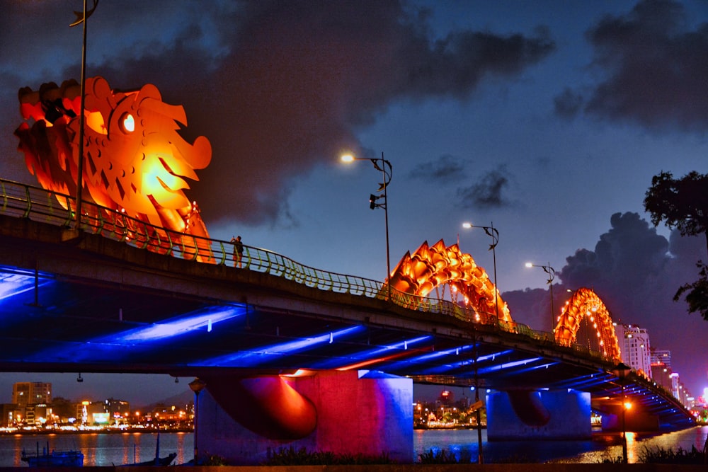 a bridge that has a lit up dragon on it