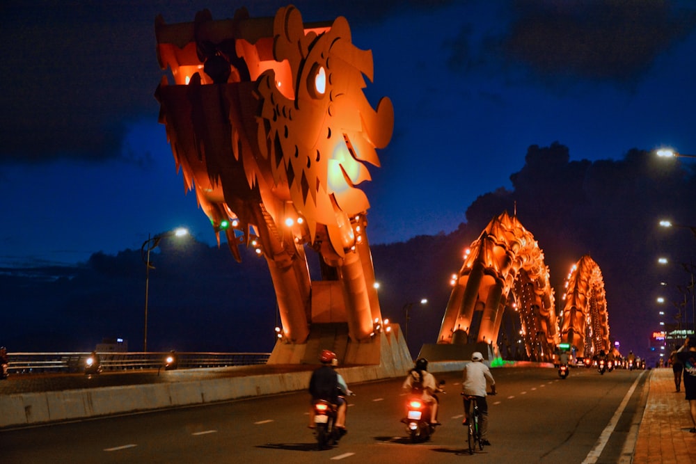 a group of people riding motorcycles down a street