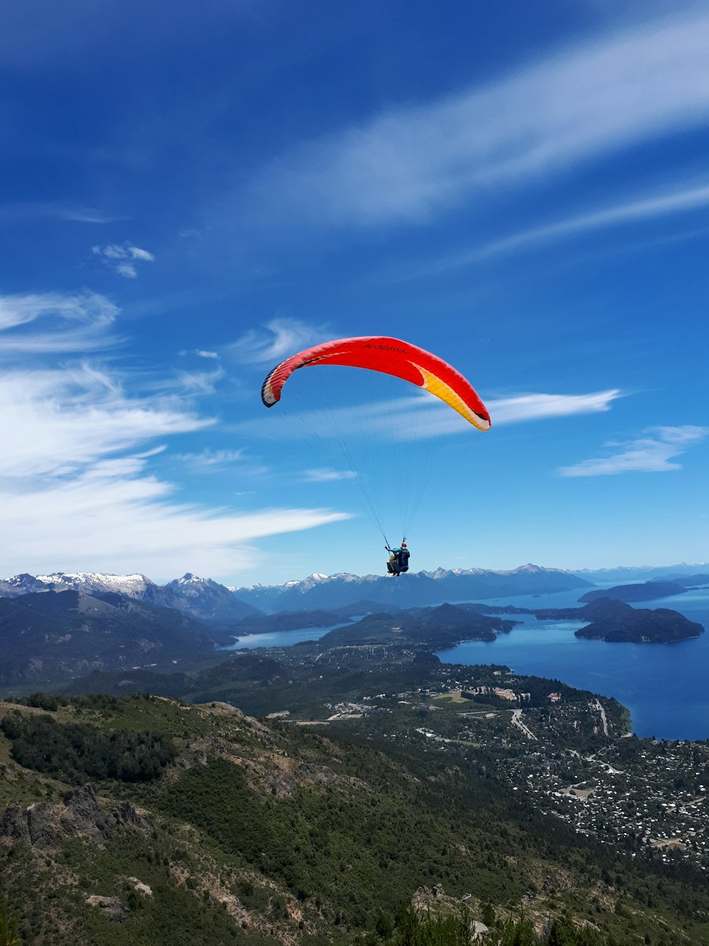 a person is parasailing over a large body of water