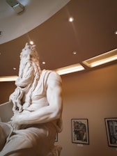 A craftsman carefully installing a custom statue in a bright, renovated living room.