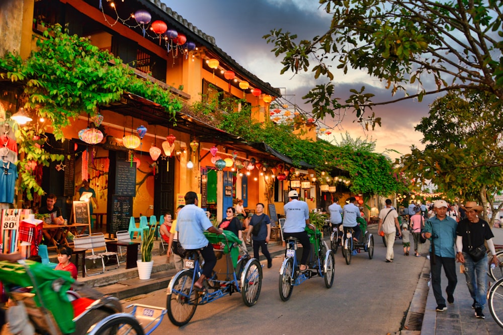 a group of people riding bikes down a street