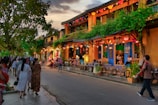A vibrant street scene at dusk, alive with color and movement.