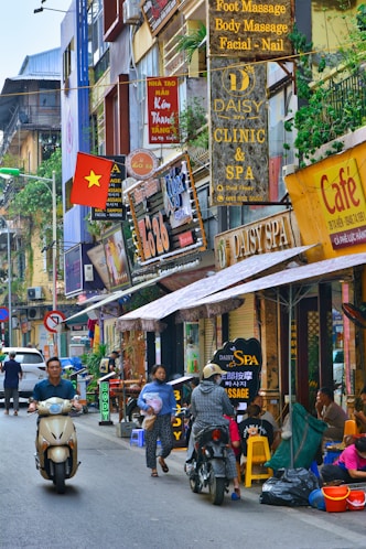 a city street full of shops in Hanoï