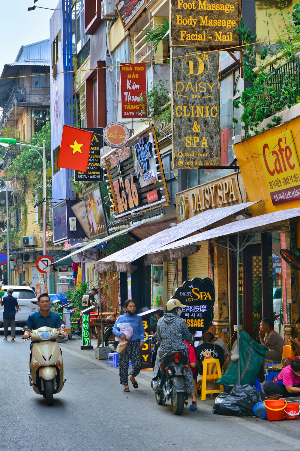 a city street filled with lots of signs and people