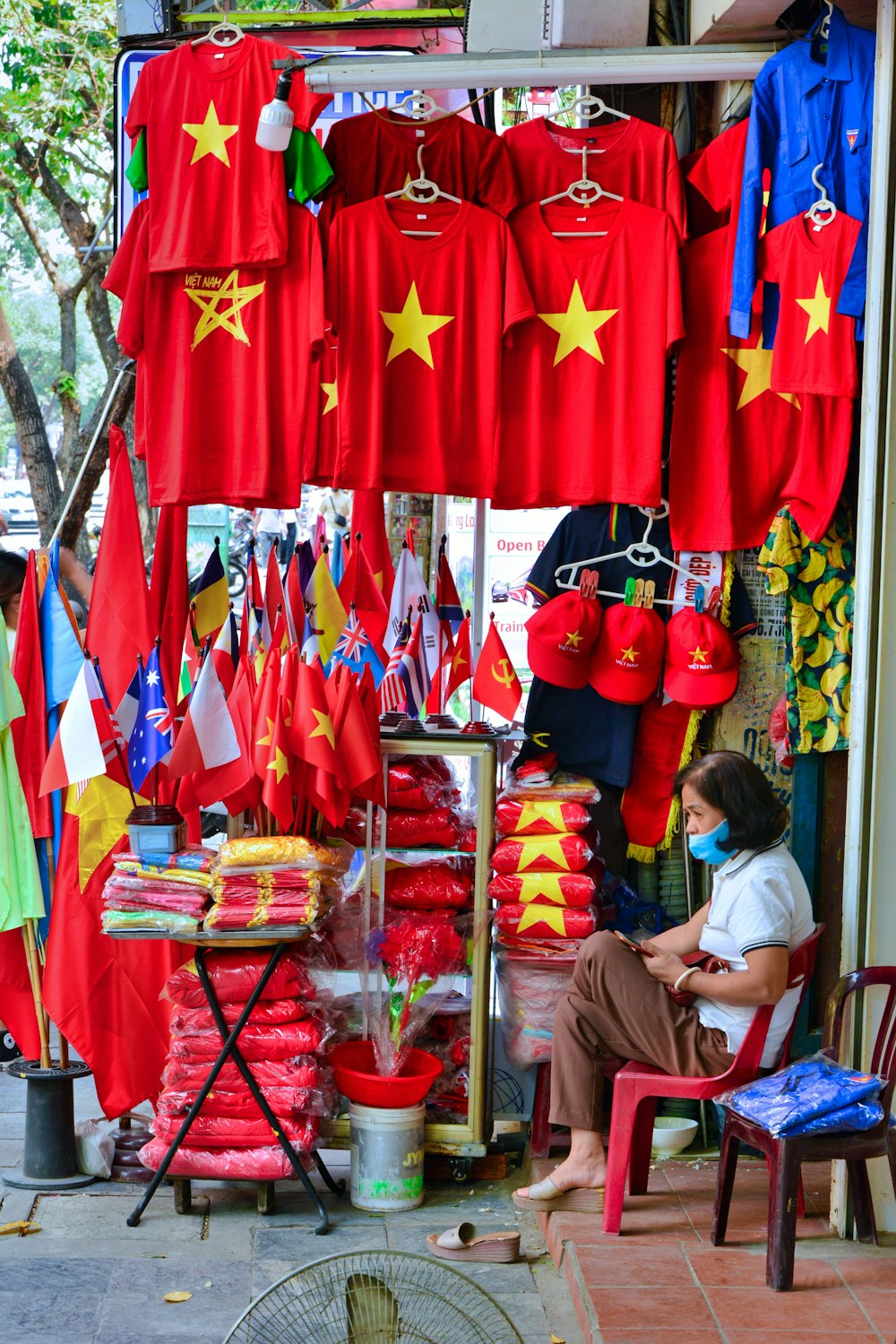 a woman sitting on a chair in front of a store