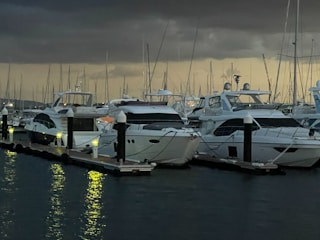 A row of sleek yachts docked in covered slips at sunset on Bear Lake.