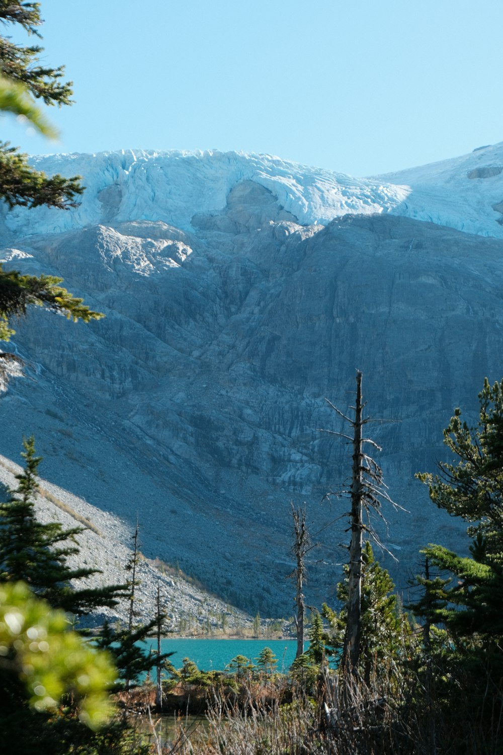 a view of a mountain range with a lake in the foreground