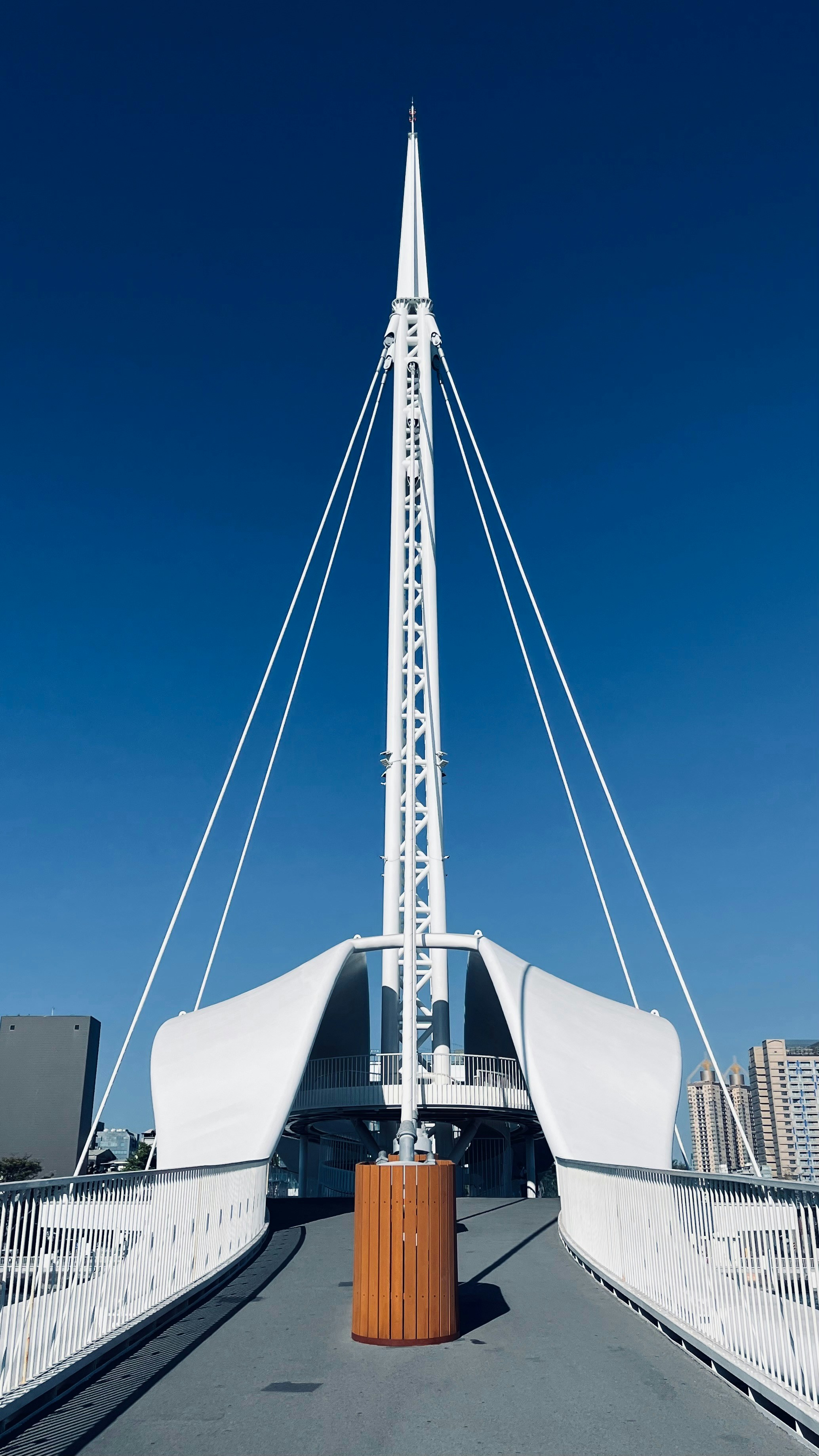 a tall white building with a metal structure on top of it