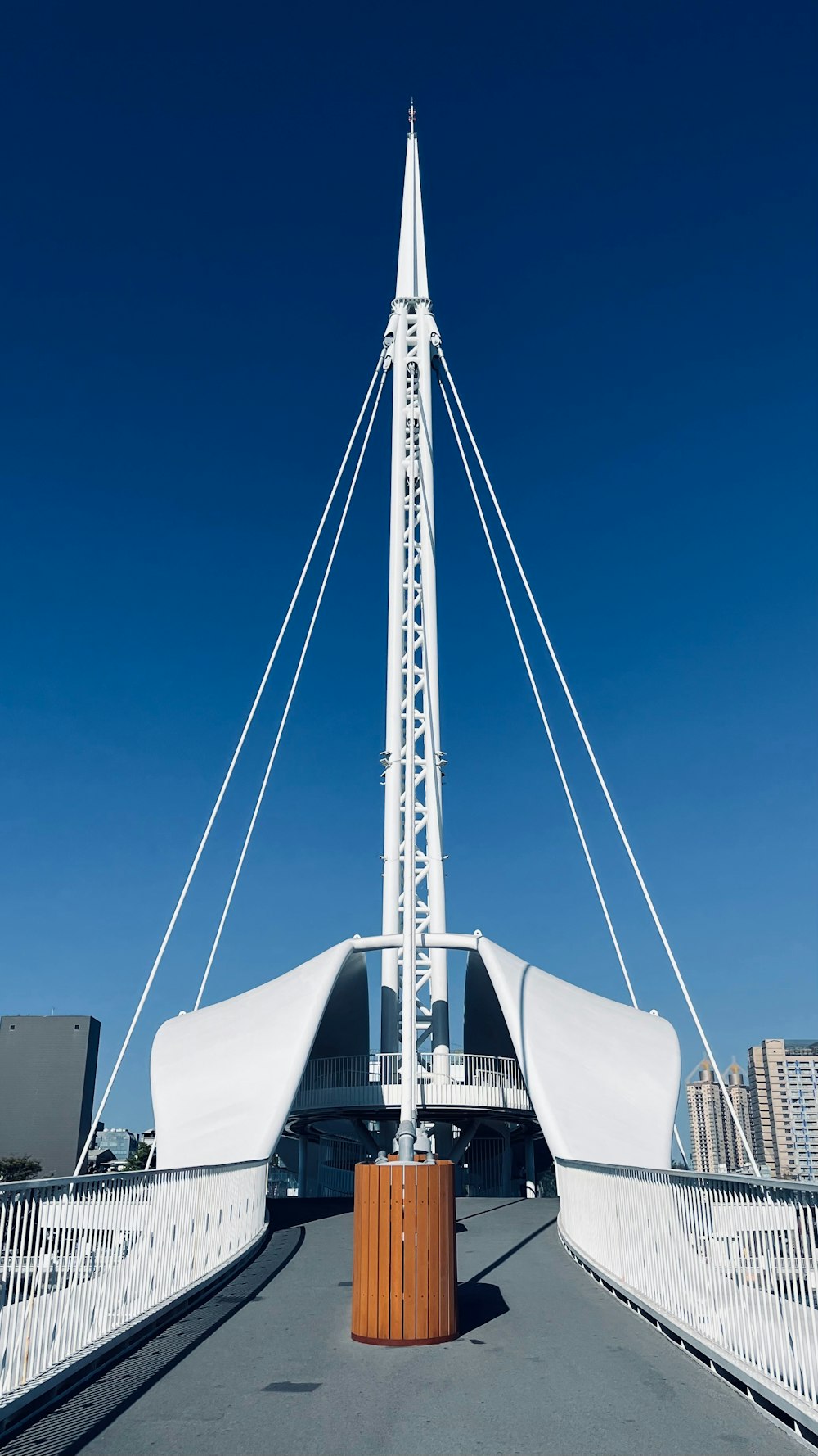 a tall white building with a metal structure on top of it