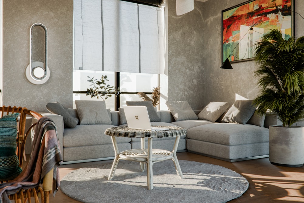 a living room with a couch a table and a laptop