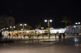 A contemporary public plaza with geometric landscaping and subtle lighting at dusk.