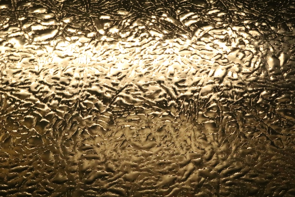 a close up of a glass window with drops of water on it