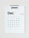 A minimalistic wall calendar for December 2023, with days of the week listed at the top starting from Monday. The calendar is predominantly white with black text and a subtle touch of gold used for Sundays and the number 25, suggesting Christmas.