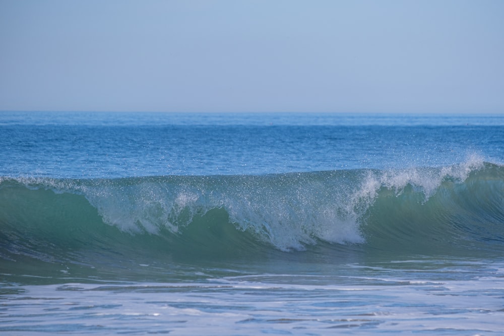 a person riding a wave on top of a surfboard