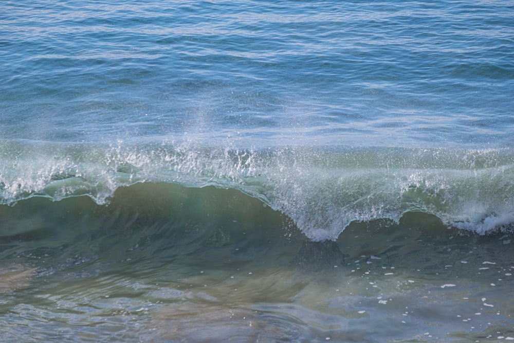 a man riding a wave on top of a surfboard