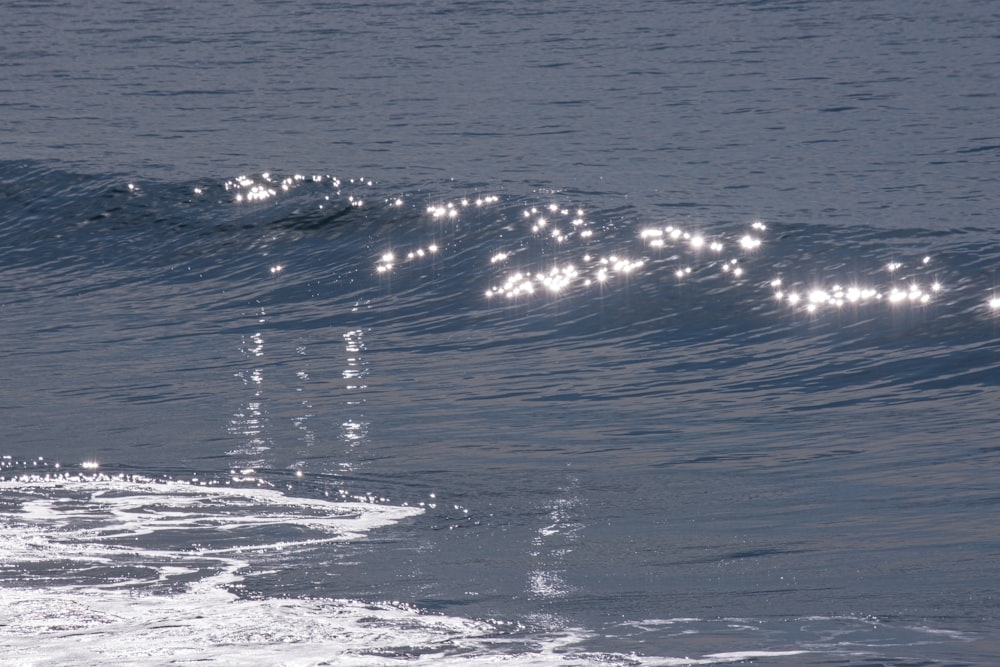 a man riding a wave on top of a surfboard