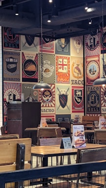 A cozy restaurant counter with colorful tacos, burgers, and pizzas on display.
